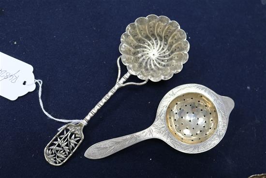 A Chinese silver sugar bowl and two tea strainers.